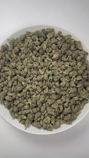 PUFFY White Truffle (smalls) is an indica-dominant hybrid THCa strain, crafted from the legendary lineage of Gorilla Butter, a standout phenotype of Gorilla Glue #4 × Peanut Butter Breath. The aroma is rich and inviting, with doughy undertones layered over an earthy base and a distinctly pungent finish that lingers pleasantly in the air. Visually striking, these medium-sized buds glisten under a thick frost of white trichomes, with vibrant orange pistils winding through deep green and purple tones. Consumer