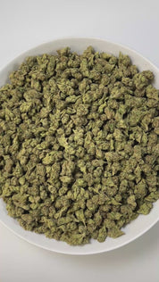 PUFFY King Gelato (smalls) is an indica-dominant hybrid THCa strain created from the potent pairing of High Octane and Curelato. The aroma presents a bold, fuel-like gasoline note, layered with sharp chemical undertones and rounded out by a smooth, rich buttery scent for a complex and striking fragrance. Visually, the dense buds showcase deep forest greens with dark accents, bright orange pistils, and a thick layer of sparkling trichomes. Consumers often describe an invigorating yet soothing experience, whe