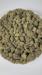 PUFFY Blueberry ZKZ is an indica-dominant hybrid THCa strain, crafted from the legendary lineage of Blueberry × ZKZ. The aroma blends sweet berry and candy notes with a bold, fuel-like edge, creating a strikingly sweet yet gassy scent profile. Visually, the buds are dense with subtle blue hues, vibrant orange pistils, and a thick, shimmering coating of frosty trichomes. Consumers often report an uplifted mood and creative spark accompanied by a relaxing, mellow body effect, with increased appetite.
