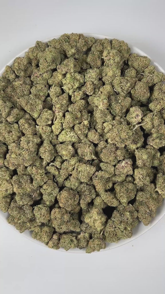 PUFFY Blueberry ZKZ is an indica-dominant hybrid THCa strain, crafted from the legendary lineage of Blueberry × ZKZ. The aroma blends sweet berry and candy notes with a bold, fuel-like edge, creating a strikingly sweet yet gassy scent profile. Visually, the buds are dense with subtle blue hues, vibrant orange pistils, and a thick, shimmering coating of frosty trichomes. Consumers often report an uplifted mood and creative spark accompanied by a relaxing, mellow body effect, with increased appetite.
