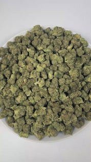 PUFFY Jokerz Candy is an indica-dominant hybrid THCa strain, born from the flavorful cross between Gummiez and Grape Gasoline. The aroma bursts with a bold fusion of sweet grape, pungent diesel, and earthy herbal notes, delivering a distinctive and captivating scent. Visually, the dense buds display forest-green tones with deep purple hues, vibrant orange pistils, and a frosty trichome coating. Consumers often describe the effects as euphoric and uplifting, promoting happiness and mental clarity, followed b