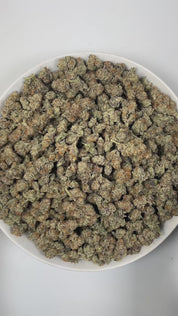 PUFFY Blueberry Muffin is an indica-dominant hybrid THCa strain, crafted by crossing the renowned Blueberry with Purple Panty Dropper. The aroma bursts with vibrant fruity notes, accented by a sweet, candy-like essence and lively, zesty highlights that create an invigorating and uplifting scent. Visually, the buds are dense, with rich green and purple tones, bright orange pistils, and a frosty layer of trichomes. Consumers often report a euphoric, uplifting experience that gently elevates mood, eases tensio